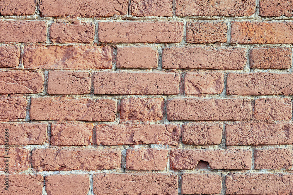 Old brick wall of bricks of different sizes as a background Old brick wall of bricks of different sizes as a background