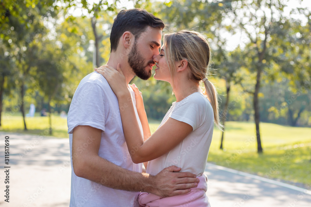 Obraz premium Couples standing kiss and hugging in the park.