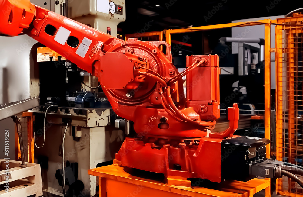 Large factory robot is operating an assembly line job Large factory robot is operating an assembly line job