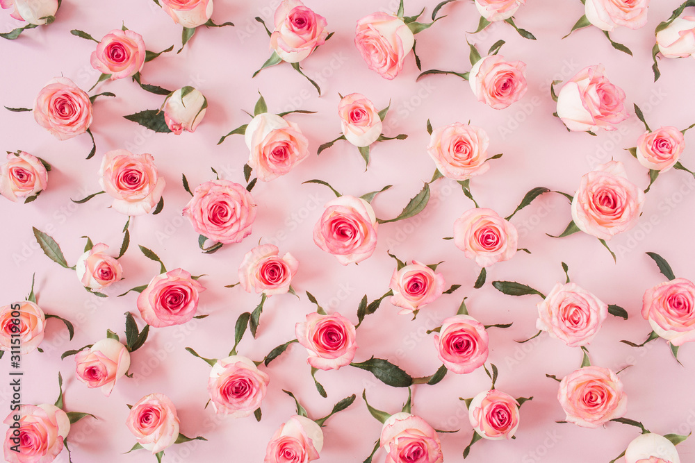 Flat lay pink rose flower buds and leaves pattern on pink background. Top view floral texture. Flat lay pink rose flower buds and leaves pattern on pink background. Top view floral texture.