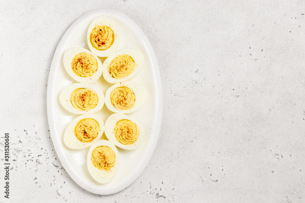 Easter snack, devilled eggs with smoked paprika. Top view, copy space. Easter snack, devilled eggs with smoked paprika. Top view, copy space.