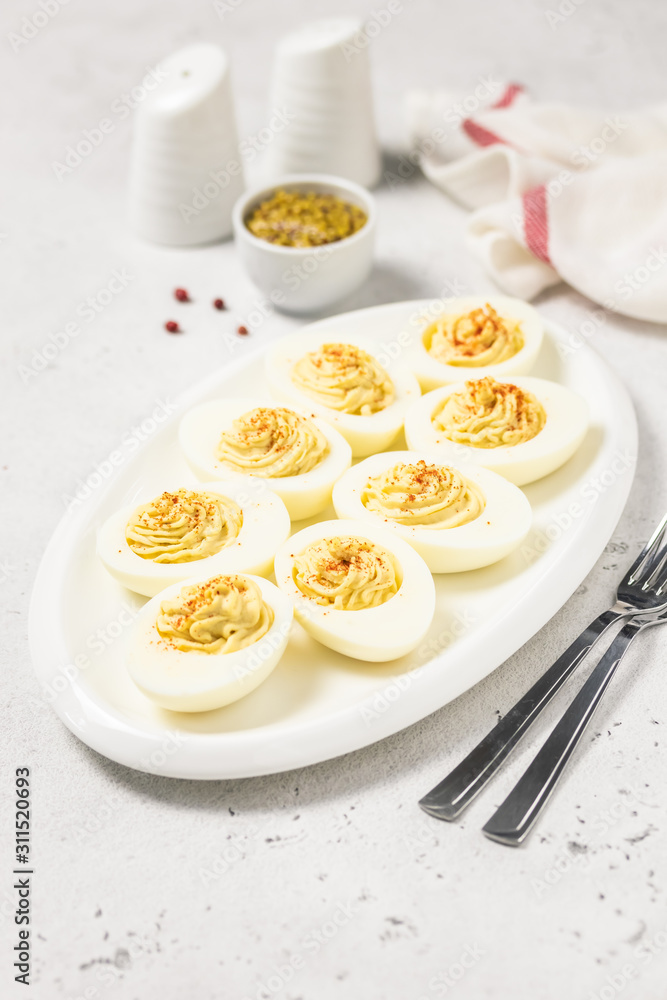 Classic devilled eggs with smoked paprika. Selective focus, copy space. Classic devilled eggs with smoked paprika. Selective focus, copy space.