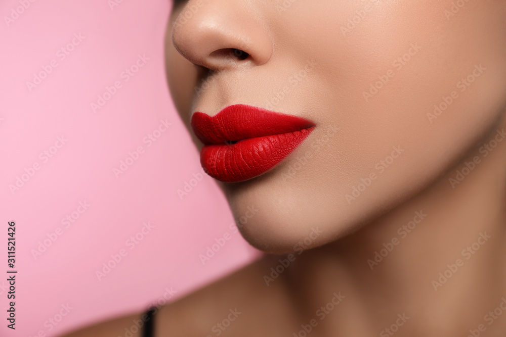 Woman with red lipstick on pink background, closeup Woman with red lipstick on pink background, closeup