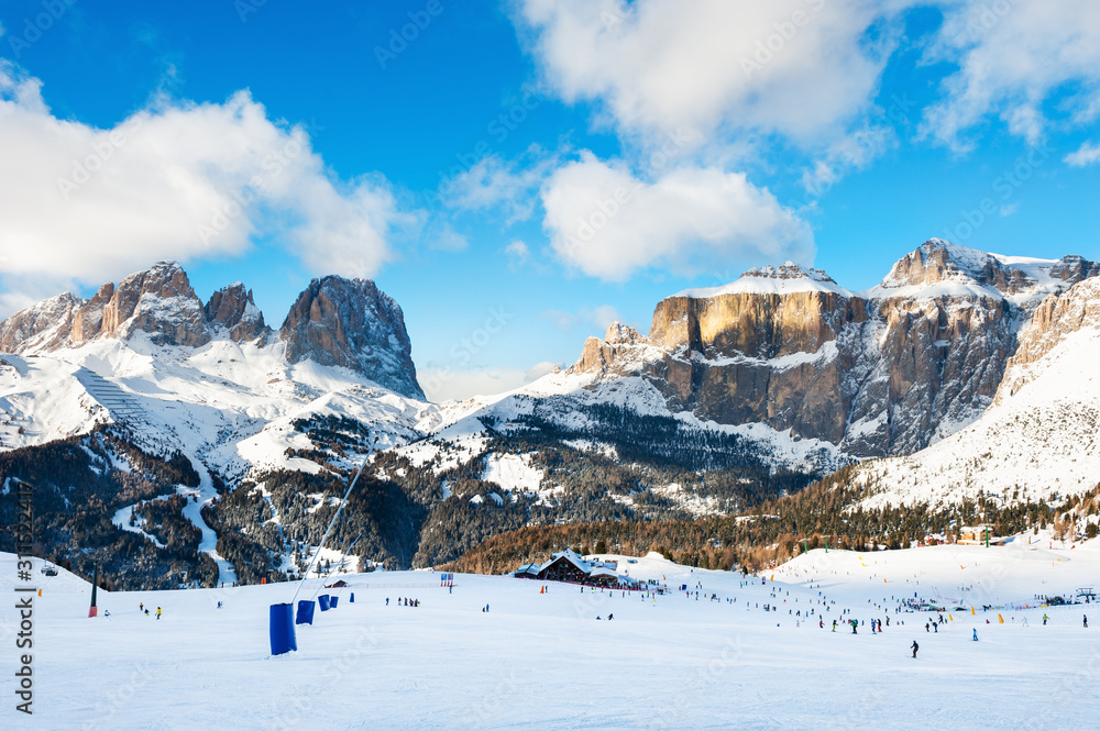 Ski slopes on ski resort in winter Dolomite Alps. Val Di Fassa, Italy. Winter holidays, travel destination