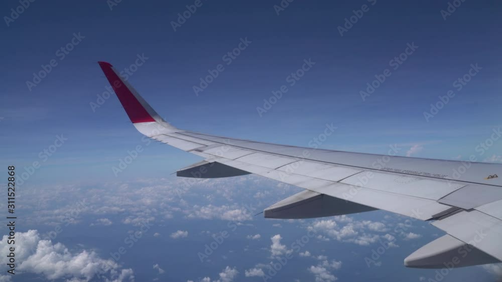 Clouds and sky as seen through window of an aircraft Clouds and sky as seen through window of an aircraft
