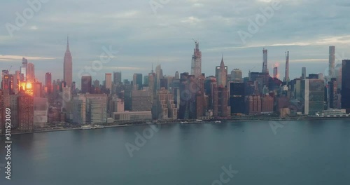 Epic timelapse of NYC East River Skyline. Empire State, chrysler building, United Nations, Sunrise to sunset, with clouds and boats. 4k+ shot on a Canon 1Dx Raw.