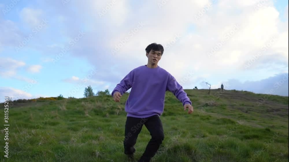 Man Stumbles and Falls Down on Grass and Rolls Down Hill Man Stumbles and Falls Down on Grass and Rolls Down Hill