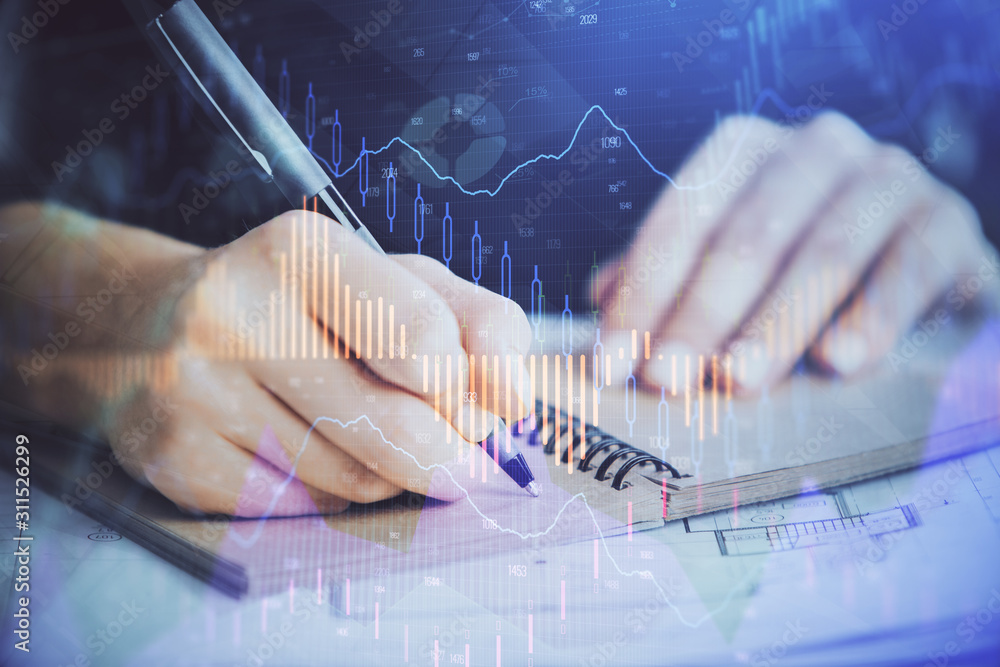 Forex graph on hand taking notes background. Concept of research. Double exposure Forex graph on hand taking notes background. Concept of research. Double exposure