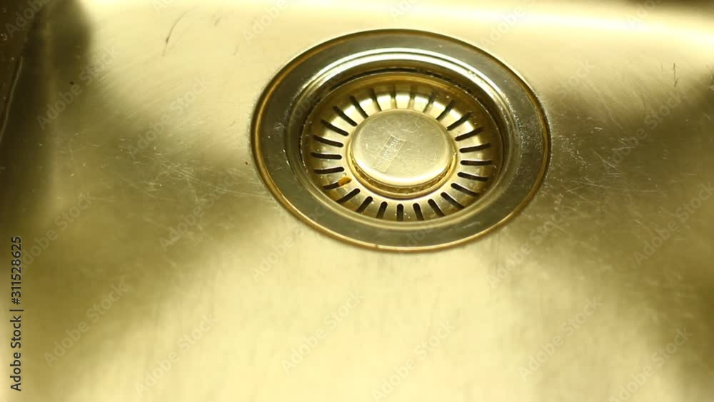 Water in a sink, flowing down, dropping, creating patterns. Water in a sink, flowing down, dropping, creating patterns.