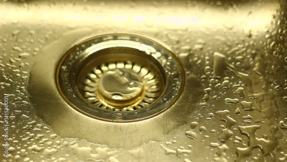 Water in a sink, flowing down, dropping, creating patterns. Water in a sink, flowing down, dropping, creating patterns.