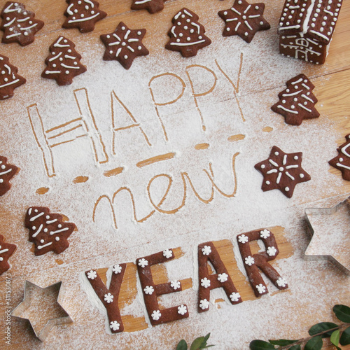 New Year's Eve background. Homemade chocolate cookies in shape of  Happy new year on a wooden table 