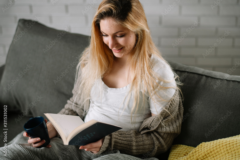 Girl at home studying. Teen reading a book on the couch. Girl at home studying. Teen reading a book on the couch.