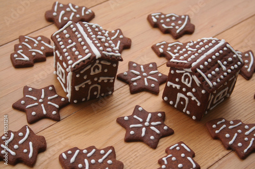Christmas background. Homemade Christmas chocolate cookies in shape of little houses and trees on a wooden table