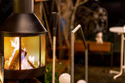outdoor wood stove with burning open fire (nighttime)