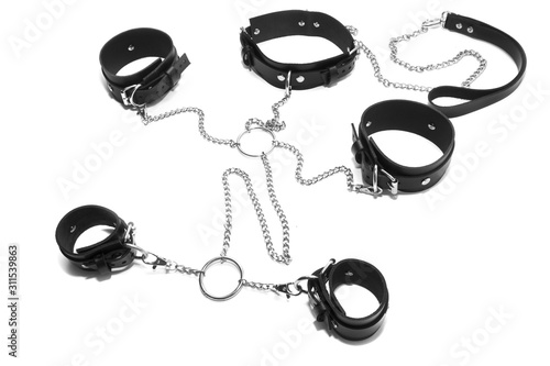 BDSM set, leather collar with a leash and leather handcuffs.