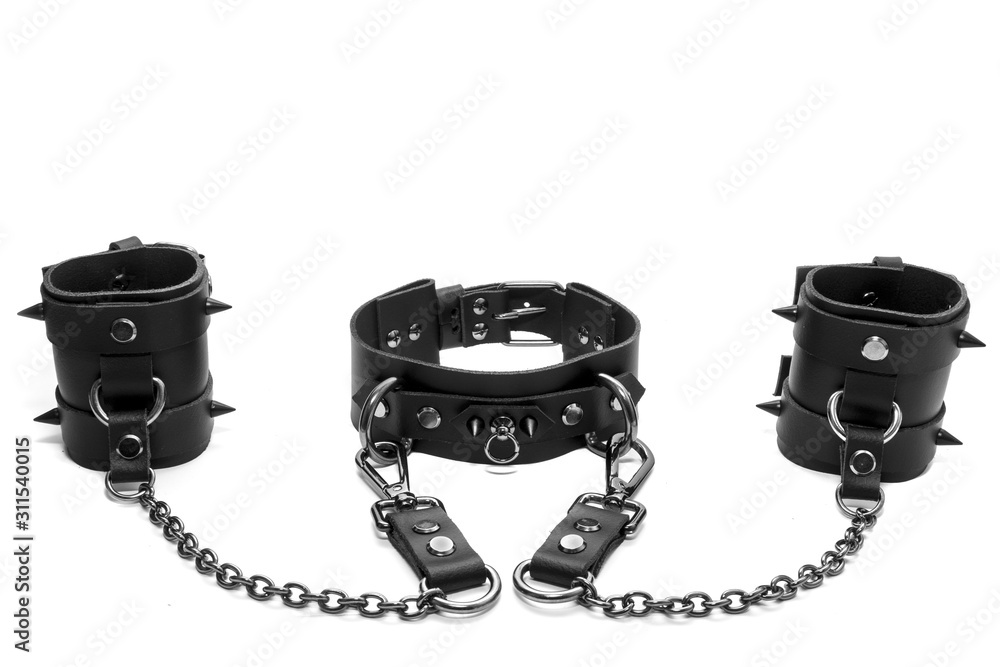 Black BDSM collar with spikes and leather bracelets on his hands Stock ...