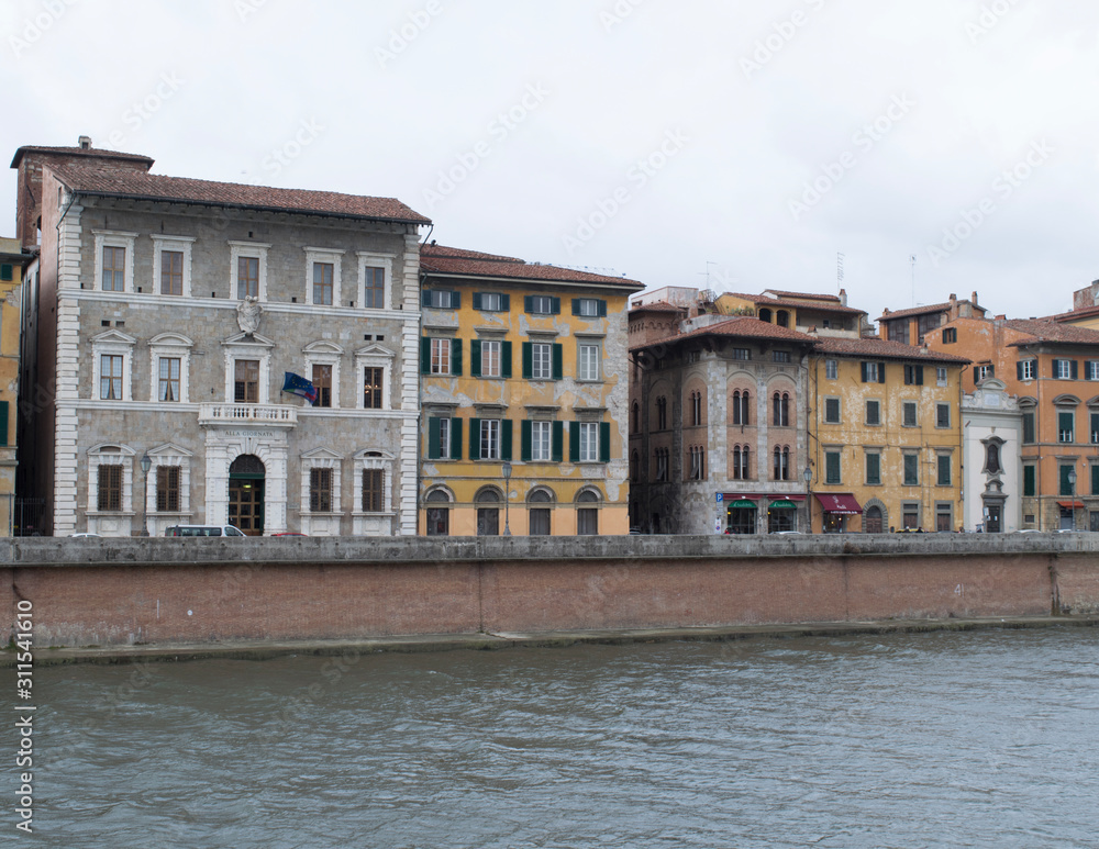 Buildings along the Arno River through Pisa, Italy