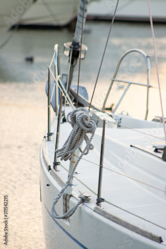 Rope coils hanging on yacht rail