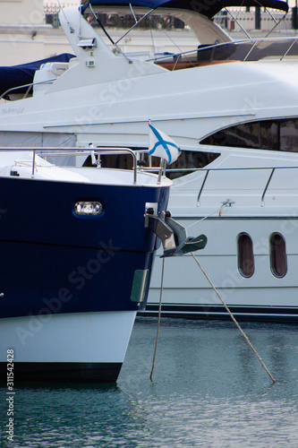The bow of a yacht moored in a marina