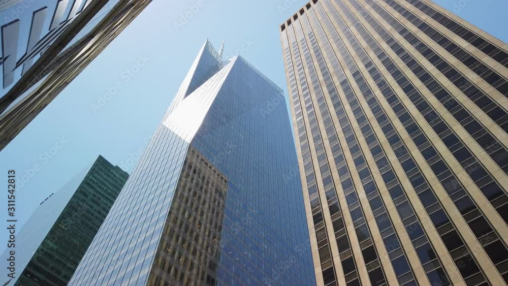 Manhattan business and financial district, modern skyscrapers in bright midday sun Manhattan business and financial district, modern skyscrapers in bright midday sun