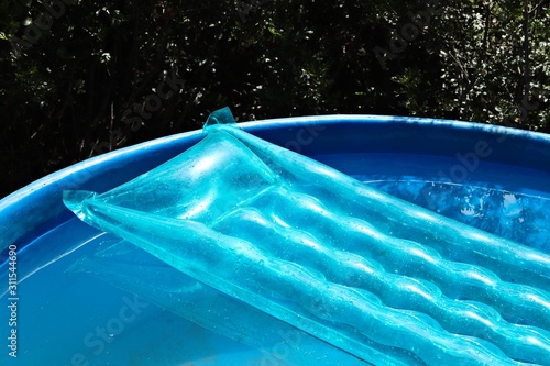 Canvas-taulu Pool drowning concept image consisting of a blue inflatable lilo surrounded by water