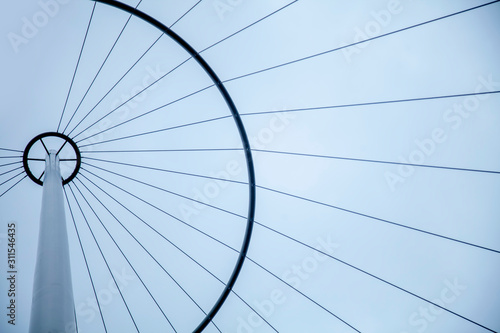 Bottom view of abstract tower background against clouded sky