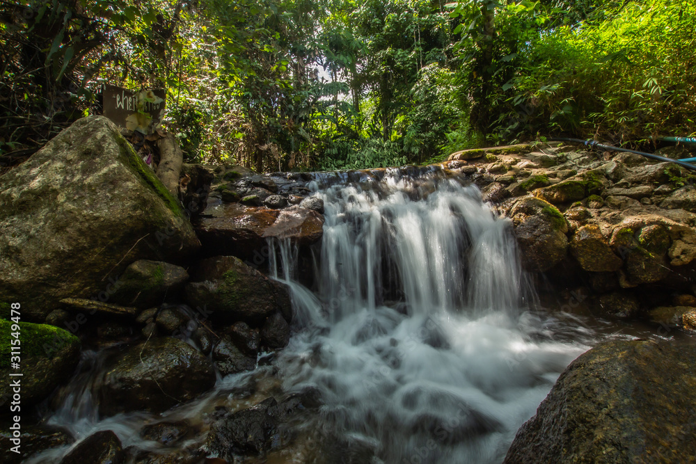 Kathu Waterfall in the tropical forest area In Asia, suitable for walks, nature walks and hiking, adventure photography Of the national park Phuket Thailand,Suitable for travel and leisure.