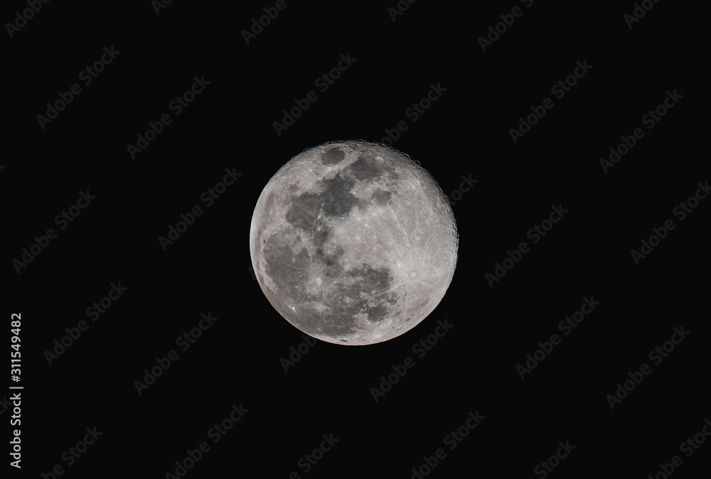 Full moon over dark black sky at night with telephoto lens isolated on transparent background. Full moon over dark black sky at night with telephoto lens isolated on transparent background.
