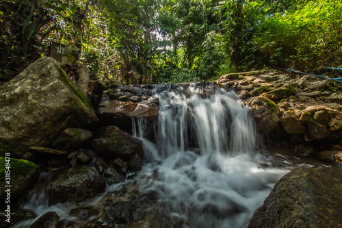 Kathu Waterfall in the tropical forest area In Asia, suitable for walks, nature walks and hiking, adventure photography Of the national park Phuket Thailand,Suitable for travel and leisure.