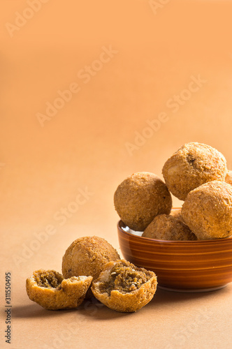 Kachori or Kachauri or Kachodi or Katchuri is a spicy snack, snacks with tea and green salad and tomato ketchup photo