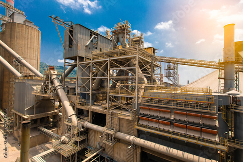 cement plant factory manufacturing have clinker cooler and other plant  at sunset.