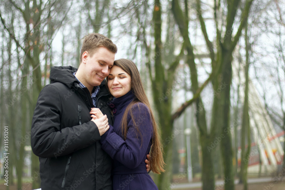 Fototapeta premium Lovely communication of husband and wife in the open air. Late autumn in perk.
