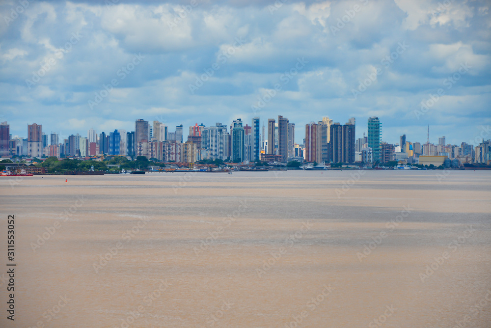 Naklejka premium View of City Belem from the Para river. Many skyscrapers and brown color water.