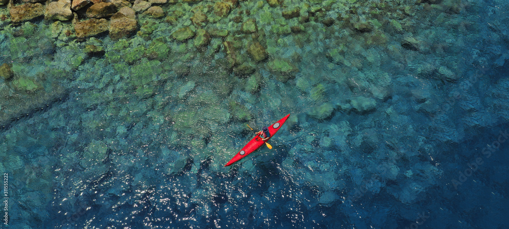 Aerial drone ultra wide photo of sport canoe in tropical exotic Pacific island bay Aerial drone ultra wide photo of sport canoe in tropical exotic Pacific island bay