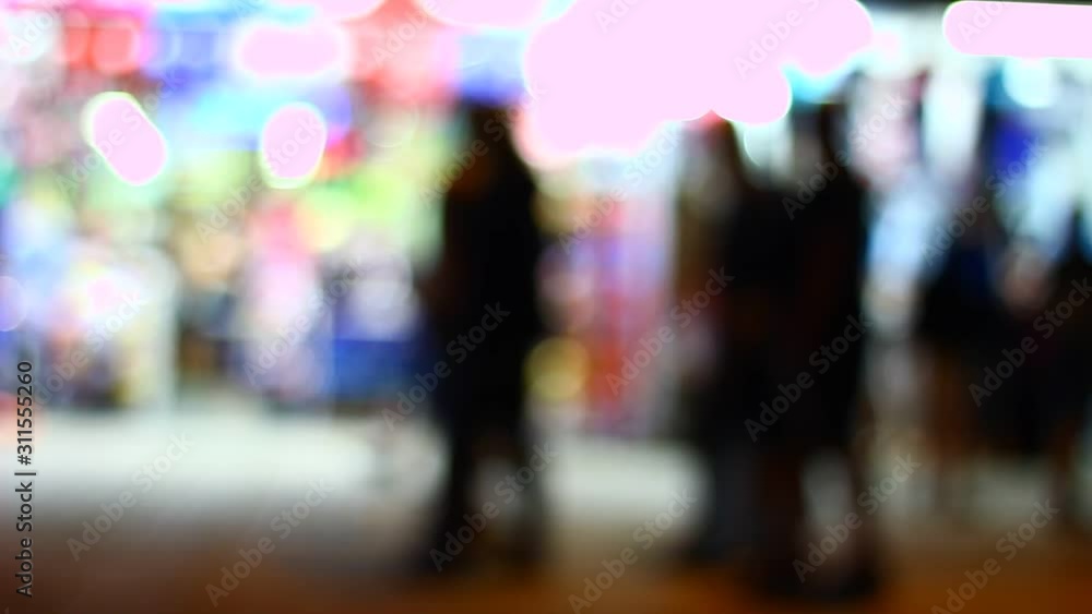 Silhouettes of people walking in the street, under strong street lights. Shadows, silhouettes of people. Silhouettes of people walking in the street, under strong street lights. Shadows, silhouettes of people.
