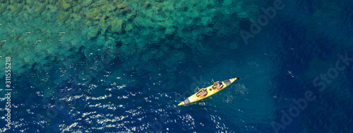 Aerial drone ultra wide photo of sport canoe in tropical exotic Pacific island bay