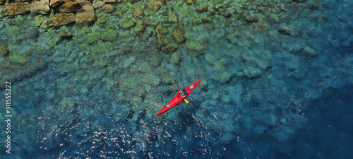 Aerial drone ultra wide photo of sport canoe in tropical exotic Pacific island bay