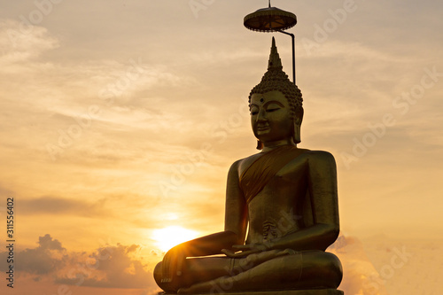 Sunset in Thailand  Buddha in Buddhism temple.  big golden buddha statue.