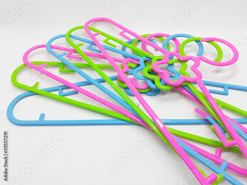 Various Bright Colorful Plastic Hanger for Clothes Drying Room Appliances in White Isolated Background 