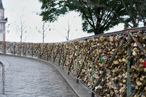 Countless colorful castles left by lovers on a fence near the temple of the Sacre Coeur Basilica.