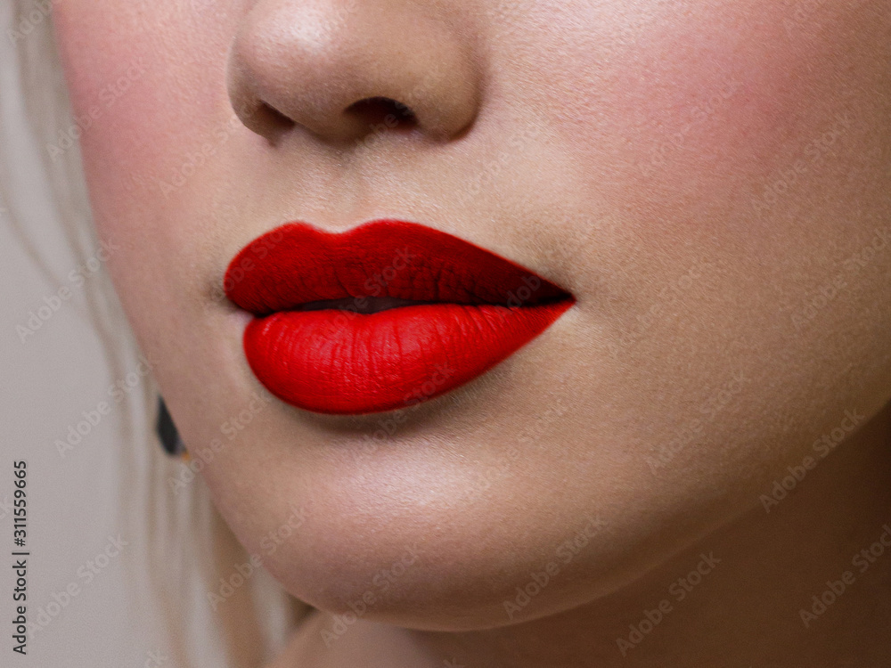 Fototapeta premium Sexual full lips. Natural gloss of lips and woman's skin. The mouth is closed. Increase in lips, cosmetology. Red lips. Great summer mood with open eyes. fashion jewelry. Pink lip gloss