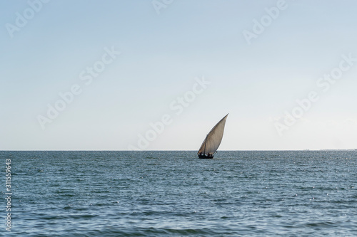 Traditional fishing sailing boat during sunset on Indian ocean in island Zanzibar, Tanzania, Africa