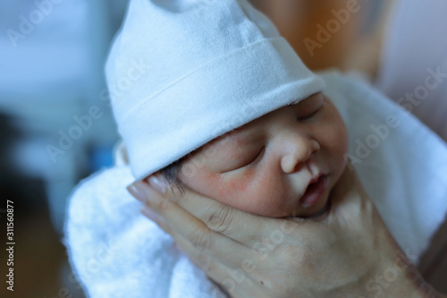 Obraz na płótnie mother parenting, mom using hand help a baby newborn belch burping after breastf