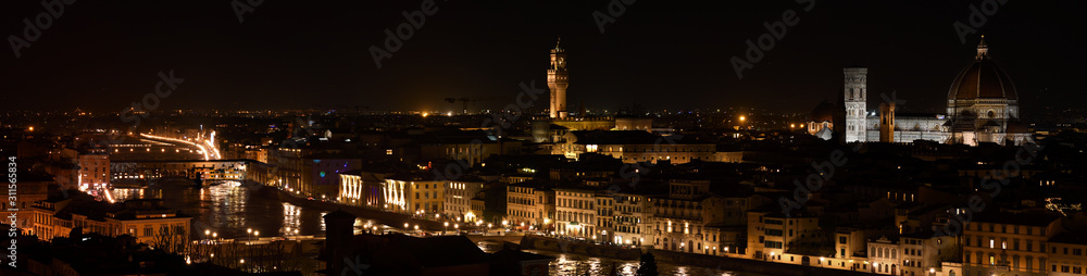 Florence, December 2019: Night view of Florence with Old Bridge, Palazzo Vecchio and Cathedral of Santa Maria del Fiore. Christmas Holidays. Italy.