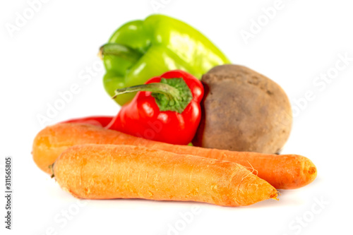 Carrots, beet, sweet red and green peppers isolated on white background.