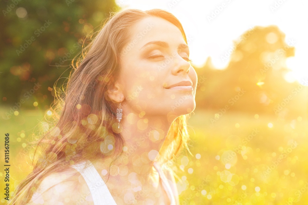 Young woman on field under sunset light Young woman on field under sunset light