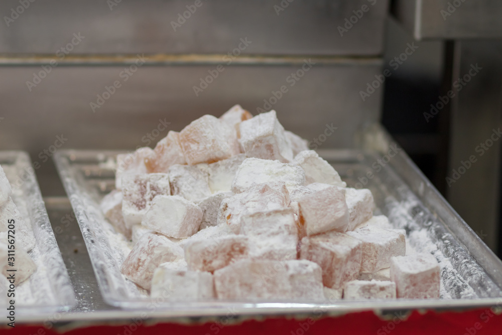 Authentic Turkish delight, arranged on trays, blurred background. In the market in Jerusalem. Authentic Turkish delight, arranged on trays, blurred background. In the market in Jerusalem.