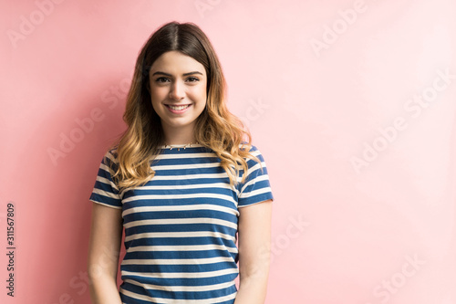 Happy Female Smiling Against Colored Background