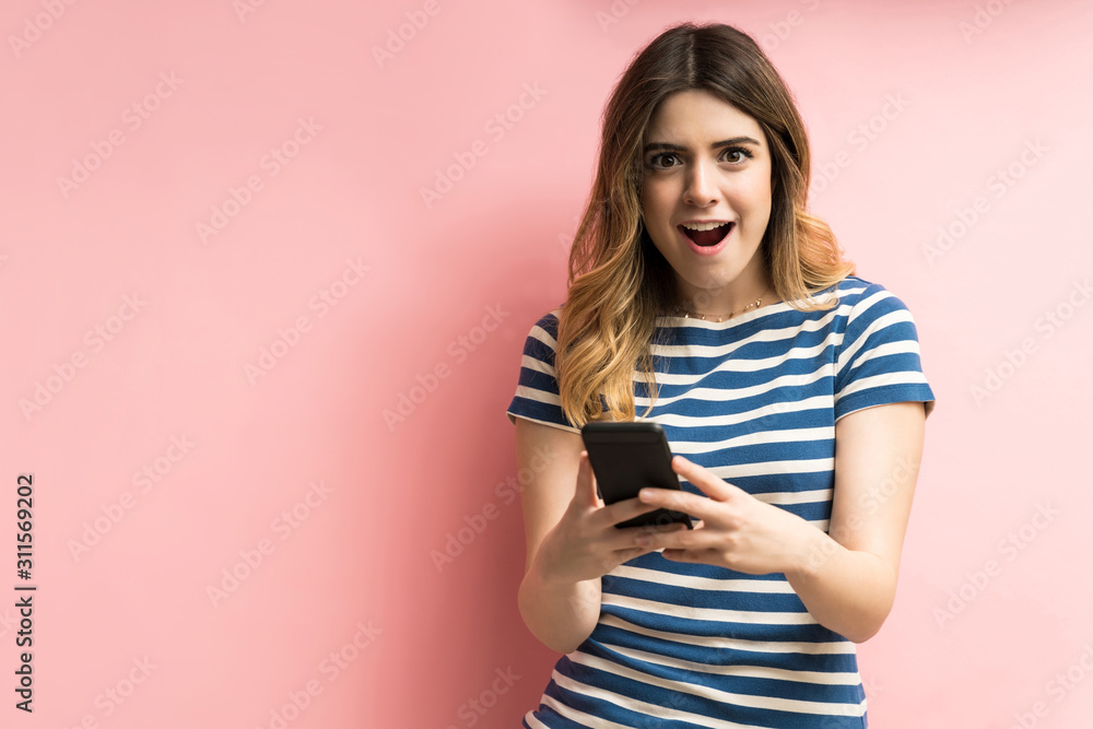 Surprised Female With Mobile Phone In Studio Surprised Female With Mobile Phone In Studio