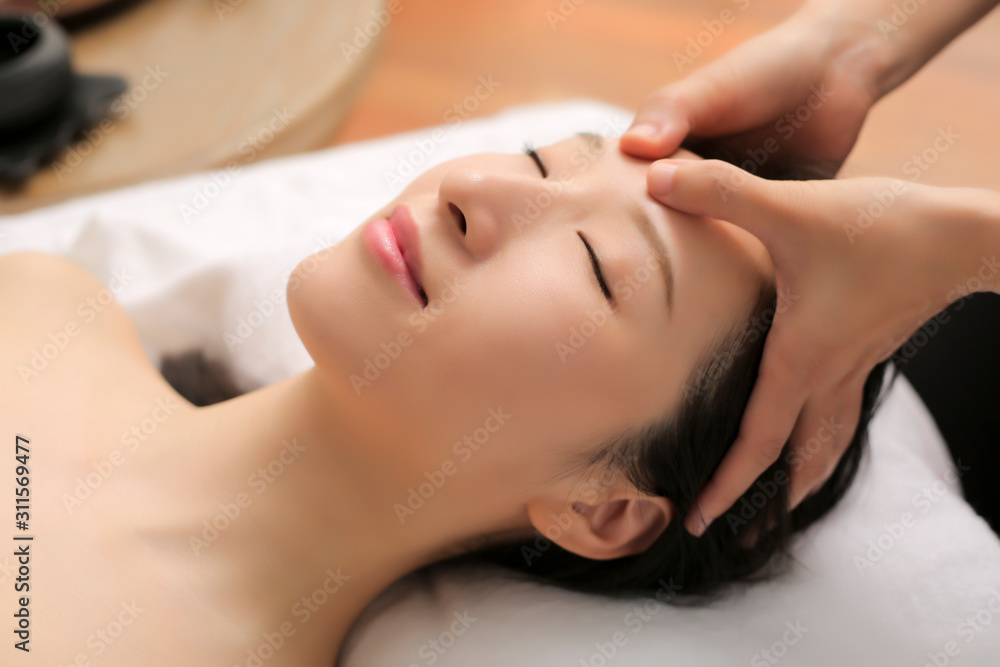 Asian women are enjoying head and face massage at spa Asian women are enjoying head and face massage at spa